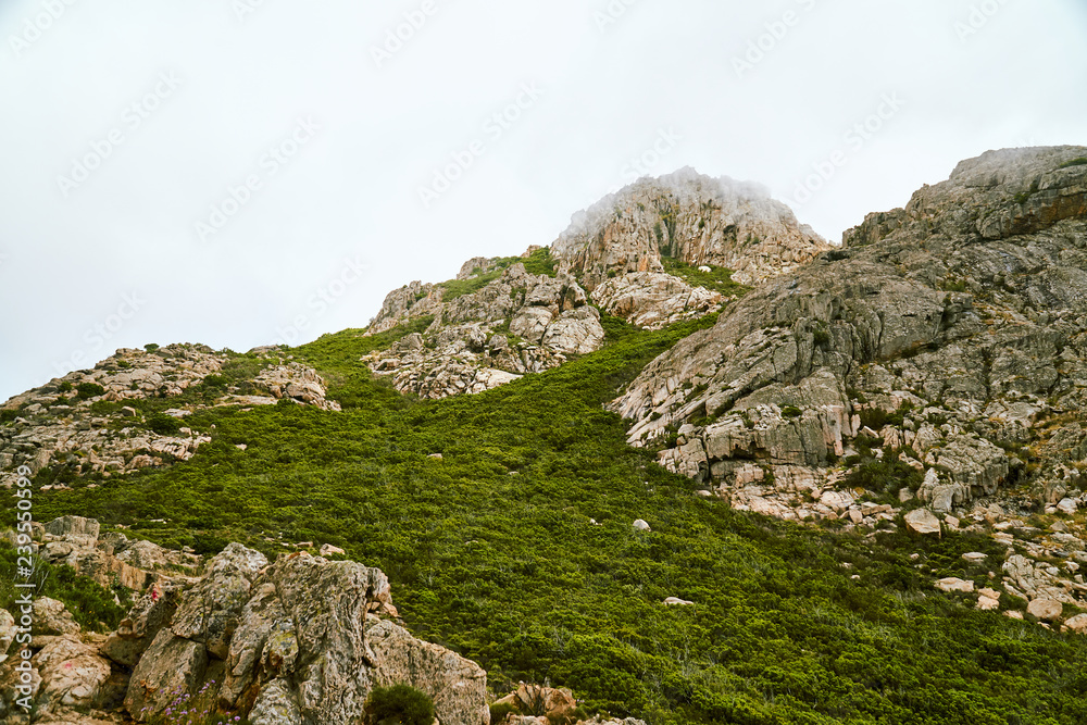 Minimalist high altitude mountain in the clouds in Corsica Corse France