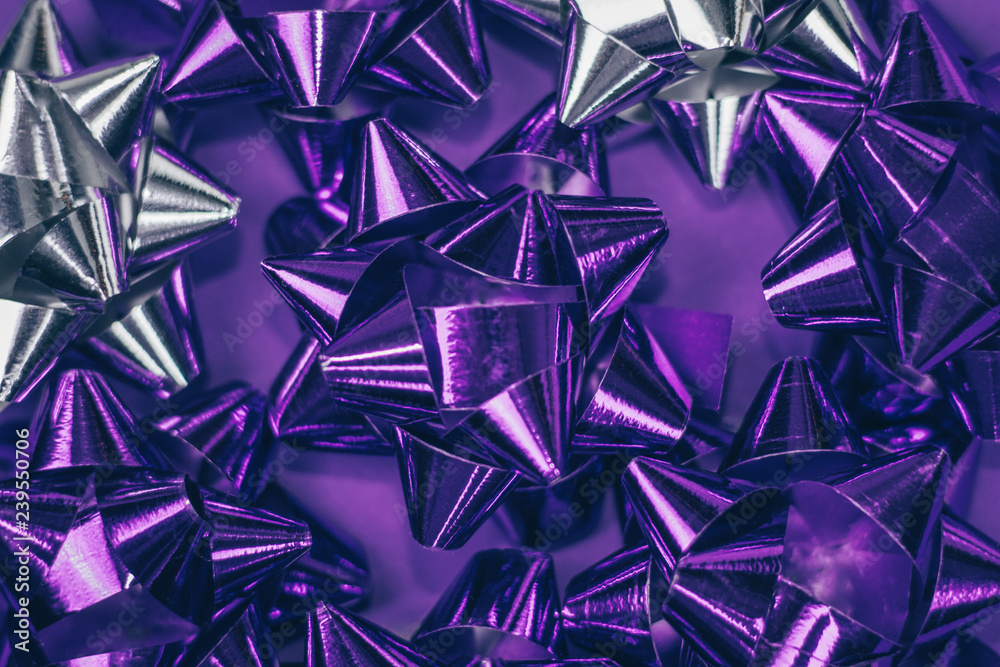 Christmas ornament of several violet and silver shiny decorations on violet background. Christmas ornament of several violet and silver shiny decorations on violet background.