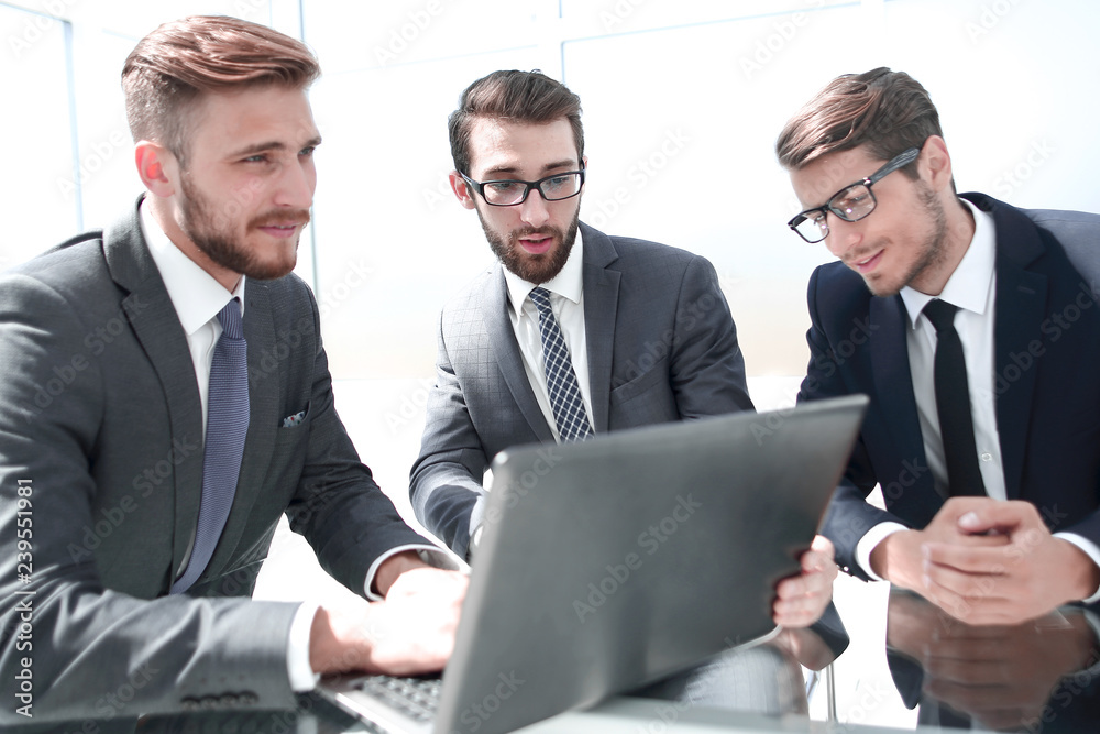 three businessman sitting at his Desk three businessman sitting at his Desk