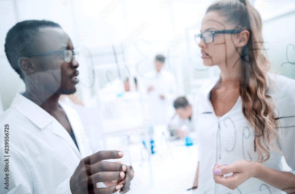 multinational scientists work in a modern laboratory multinational scientists work in a modern laboratory