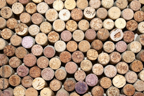 old wine corks from red wine among used wine corks from white wine and from sparkling wine as abstract brown cork background