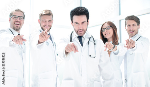 group of confident doctors pointing their finger at you