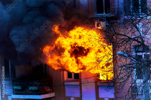 Odessa, Ukraine - Dec. 29, 2016: fire in an apartment building. Strong bright light and clubs, smoke clouds window of their burning house. Firefighters extinguish fire in house. Work on fire stairs