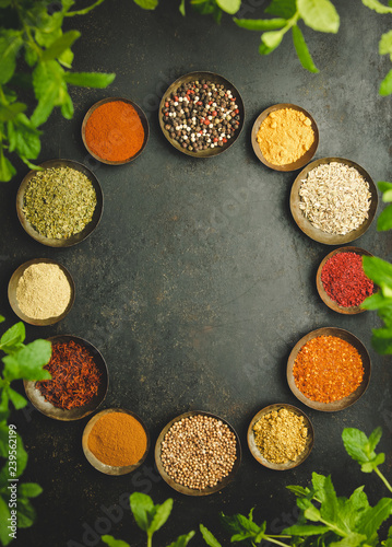 Various bowls of spices over dark background
