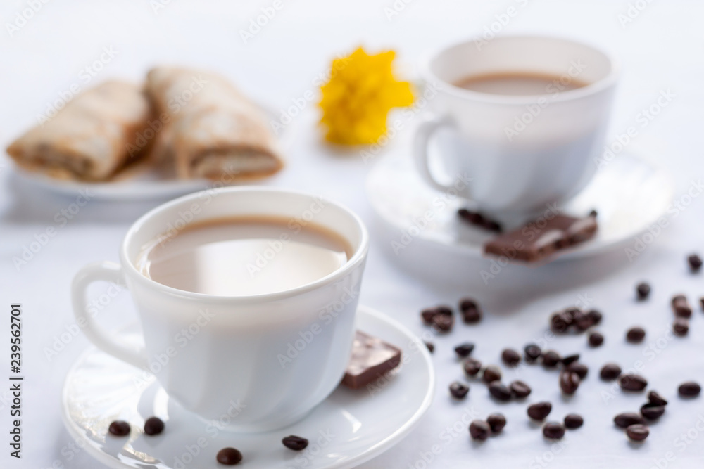 Fototapeta premium Two cup of coffee, pancakes with jam and milk chocolate. Morning breakfast for two.