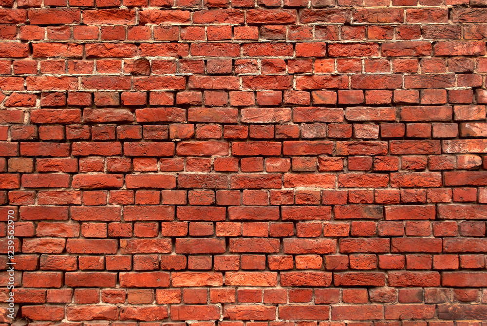 Naklejka premium Part of the old wall of red brick.