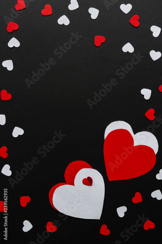 Valentines day. Paper hearts red and white on a black background. Holiday background