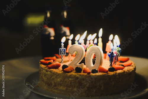 Cream cake  and number 20 candle on top.  Selective focus