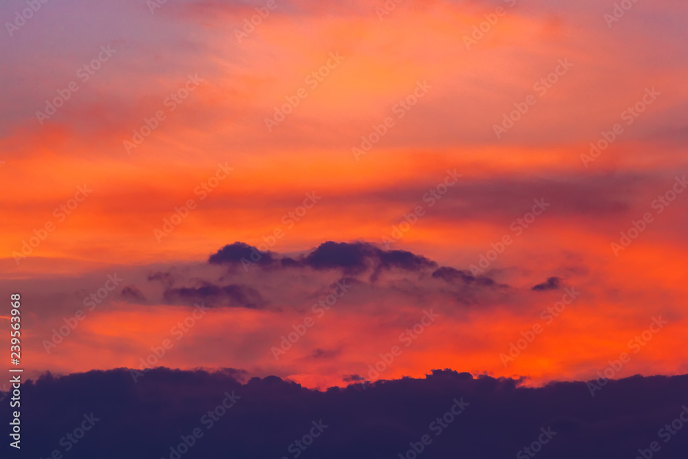 Dark red blue orange fiery clouds on the beautiful dramatic sky at sunset, close-up of shapes and silhouettes of scary nature at the weather changes. Heaven abstract landscape wallpaper.