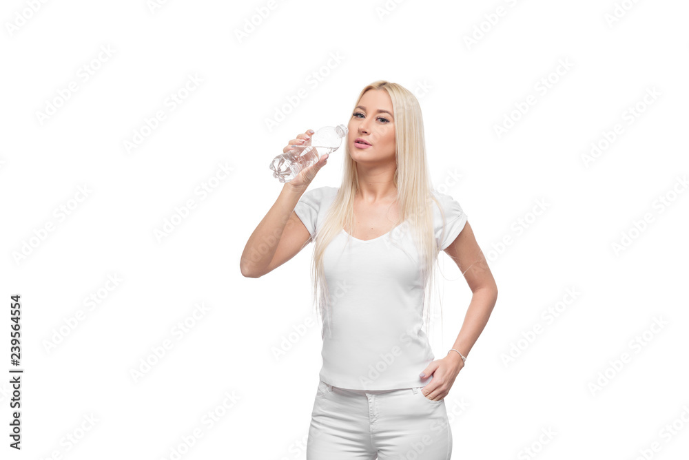 Healthy blond woman holding and drink glass of pure water on isolated white background Healthy blond woman holding and drink glass of pure water on isolated white background