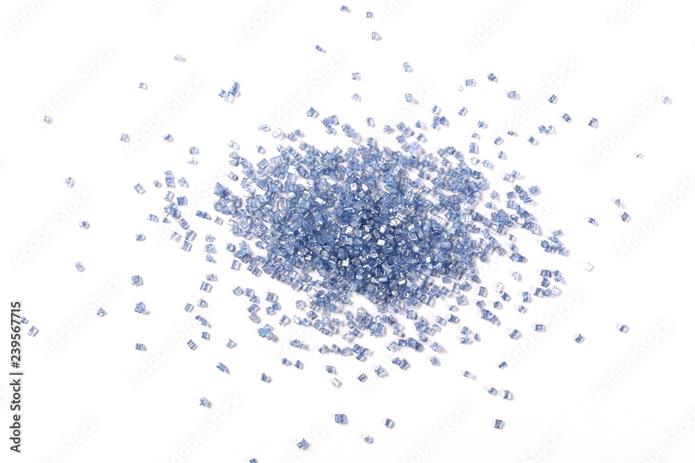 Blue crystal sugar sprinkles for cake, ice cream and pastries isolated on white background, top view