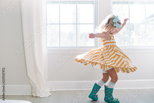 Young girl twirling in her dress