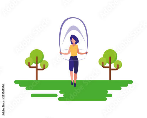 woman jumping rope near tree