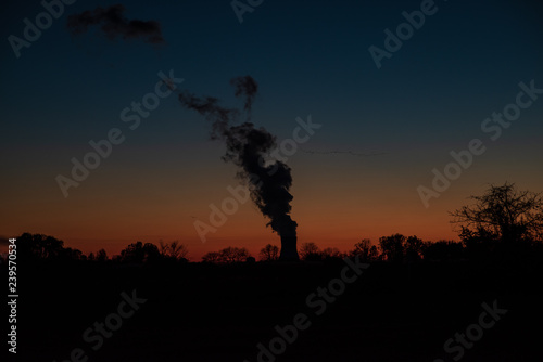 a nuclear power plant's cooling tower at sunset