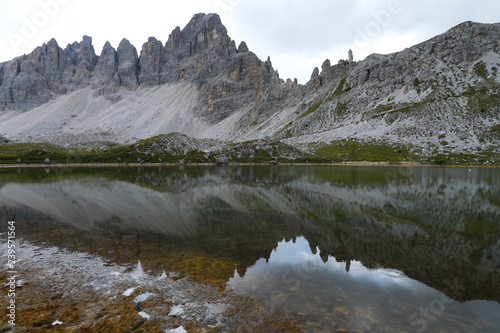Dolomite Alp mountain near the lakewith reflection in Italy