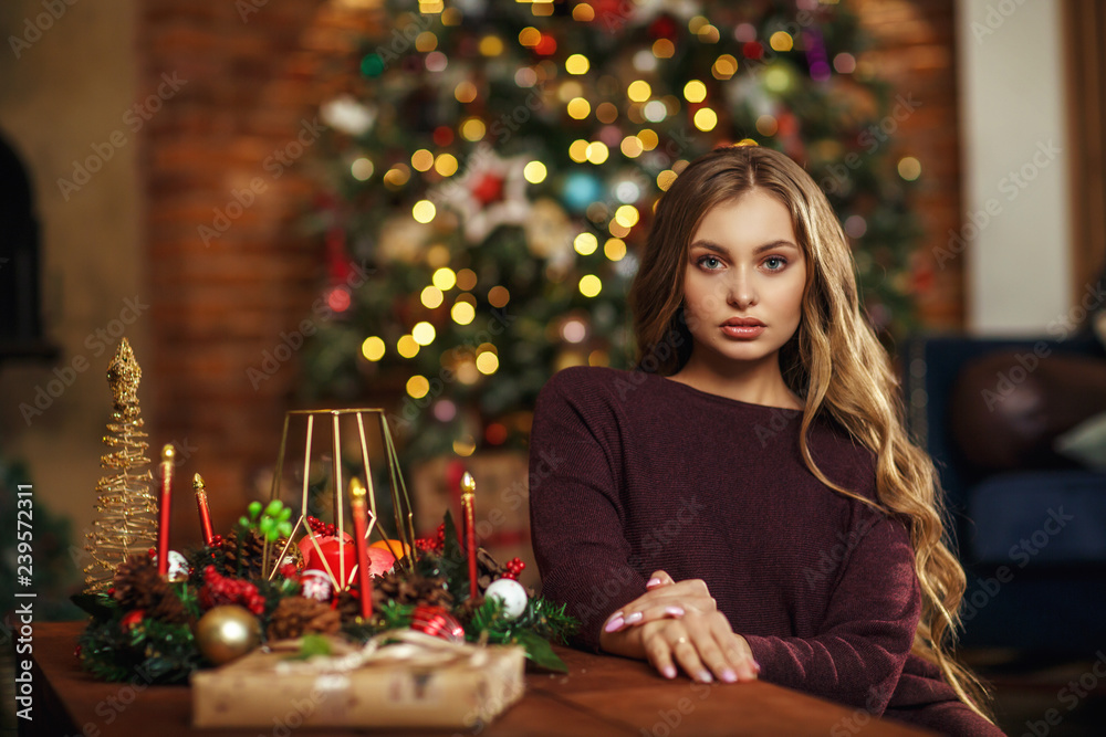 Portrait a beautiful young woman near christmas tree Portrait a beautiful young woman near christmas tree