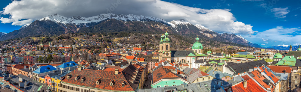 Obraz premium People in Innsbruck city center under Stadtturm tower. It is capital city of Tyrol in western Austria, Europe.