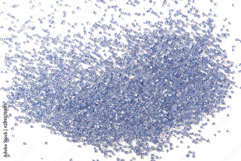 Blue crystal sugar sprinkles for cake, ice cream and pastries isolated on white background, top view