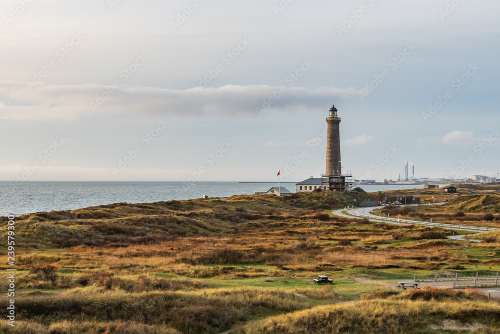 Skagen Grey Lighthouse from 1858 placed at the northernmost point in Denmark with dunes in the foreground