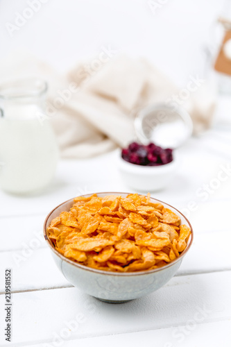 Cornflakes cereal and milk in a glass. Morning tasty breakfast concept