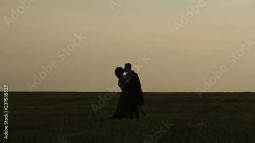 Knight with sword and girl in renaissance dress
