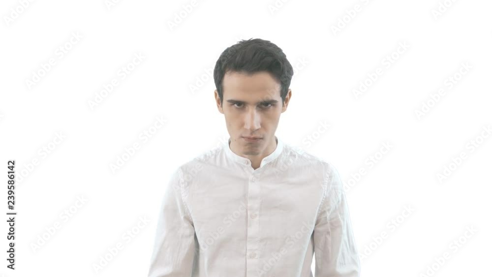 Displeased frowning angry man looking at camera isolated on white background Displeased frowning angry man looking at camera isolated on white background