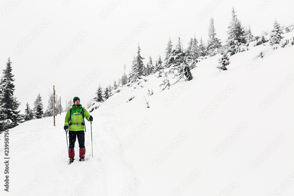 Winter hike in white, man and adventure concept