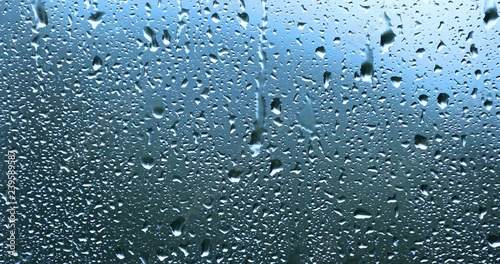 Big raindrops on window during strong storm. photo