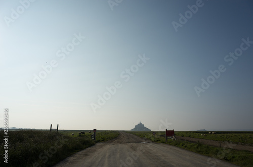 Mt. St. Michel in landscape with road and clouds