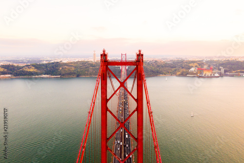 Aerial view of the 25 April bridge is a steel suspension bridge located in Lisbon, Portugal, crossing the Targus river. It is one of the most famous landmarks of the region.  photo