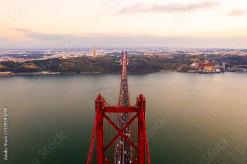 Aerial view of the 25 April bridge is a steel suspension bridge located in Lisbon, Portugal, crossing the Targus river. It is one of the most famous landmarks of the region.  photo