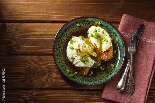 poached eggs on baguette with greens.