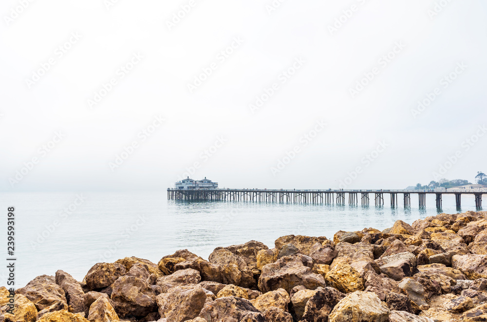 Malibu foggy pier in Southern California, Pacific coast, USA. View on the Pacific Ocean. Copy space for text.