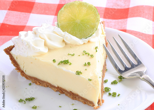 Closeup of Piece of Key Lime Pie Garnished with Lime Slice and Zest