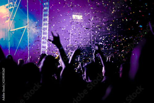 cheering crowd with raised hands and falling confetti at concert - music festival © Melinda Nagy
