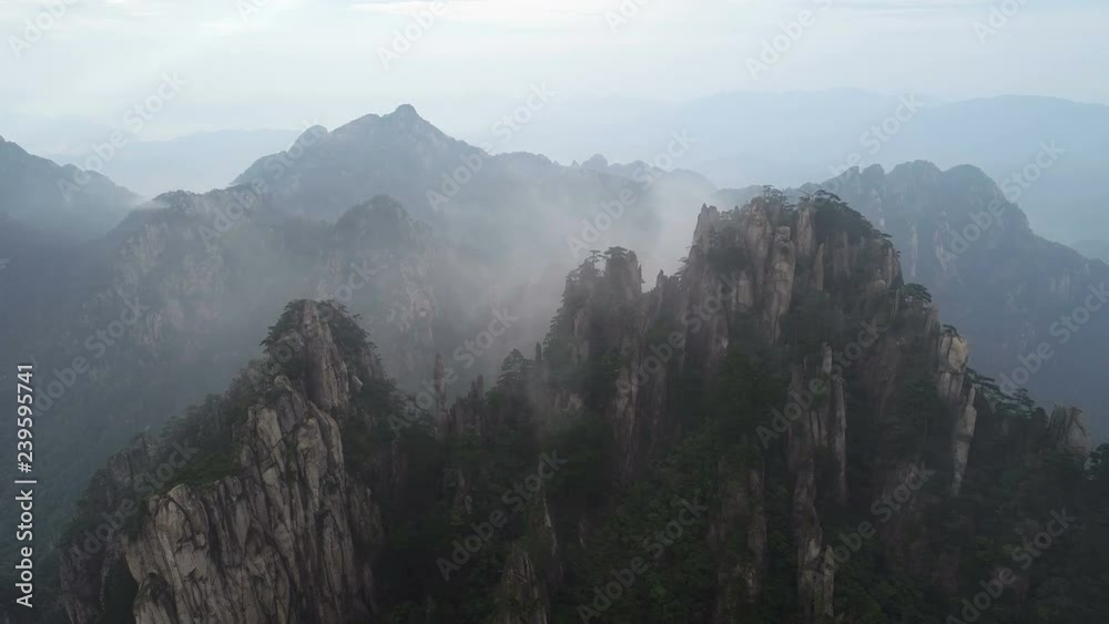 Drone shot of amazing mountain landscape in early morning fog, famous Huangshan national park in China