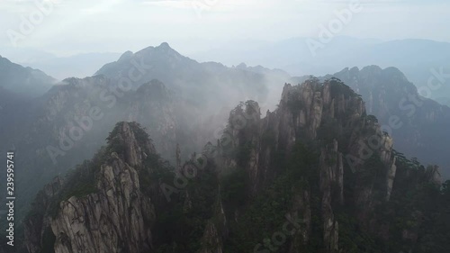 Drone shot of amazing mountain landscape in early morning fog, famous Huangshan national park in China