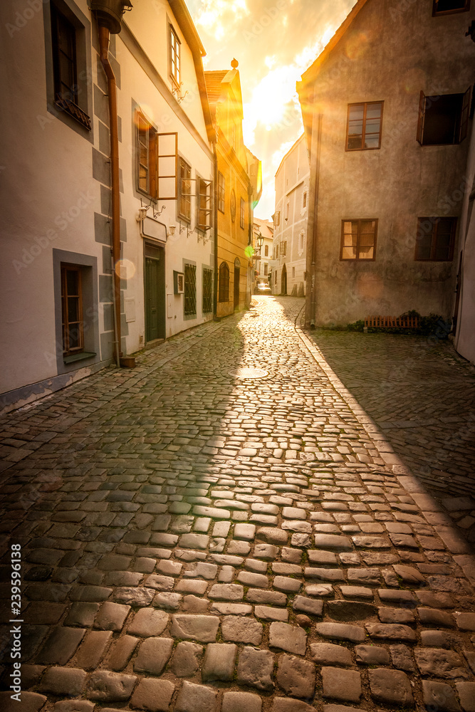 A street illuminated by the early sun. Center of the medieval town Cesky Krumlov, Czech Republic, Europe.