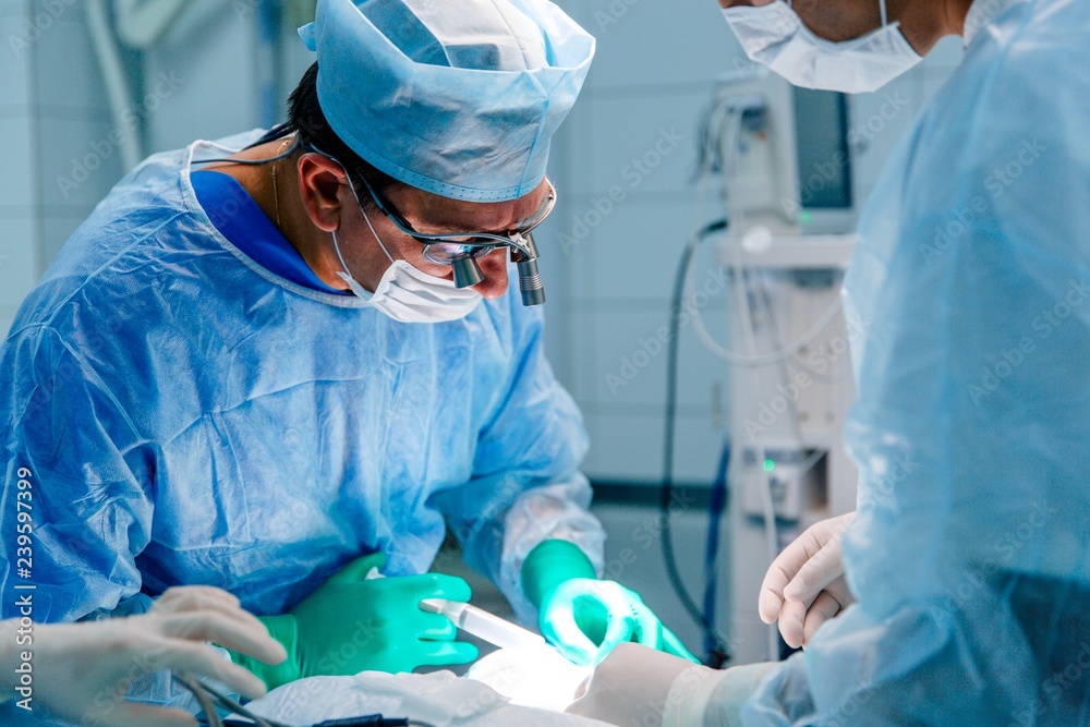 Doctor conducting the operation to the patient in the intensive care clinic Doctor conducting the operation to the patient in the intensive care clinic