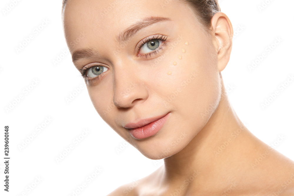 Portrait of young woman with liquid foundation on her face against white background Portrait of young woman with liquid foundation on her face against white background