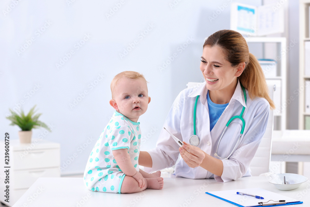 Children's doctor checking baby's temperature in hospital Children's doctor checking baby's temperature in hospital
