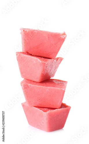 Tasty berry ice cubes on white background