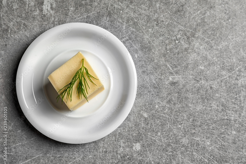 Plate with fresh butter and space for text on grey background, top view Plate with fresh butter and space for text on grey background, top view