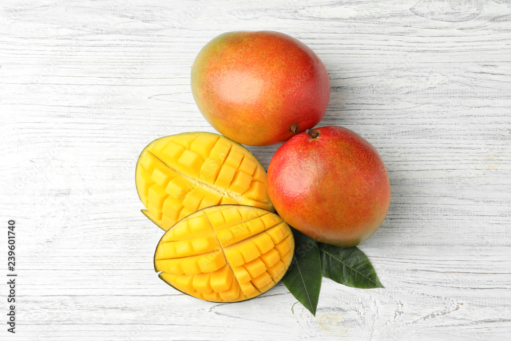 Flat lay composition with mango on white wooden background Flat lay composition with mango on white wooden background
