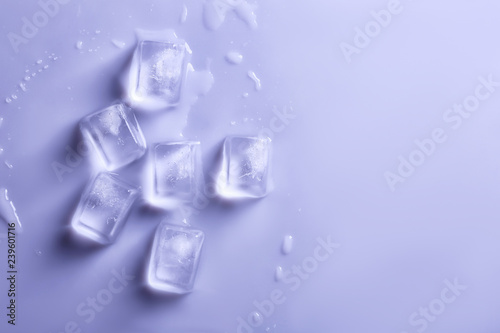 Ice cubes on color background, top view. Space for text