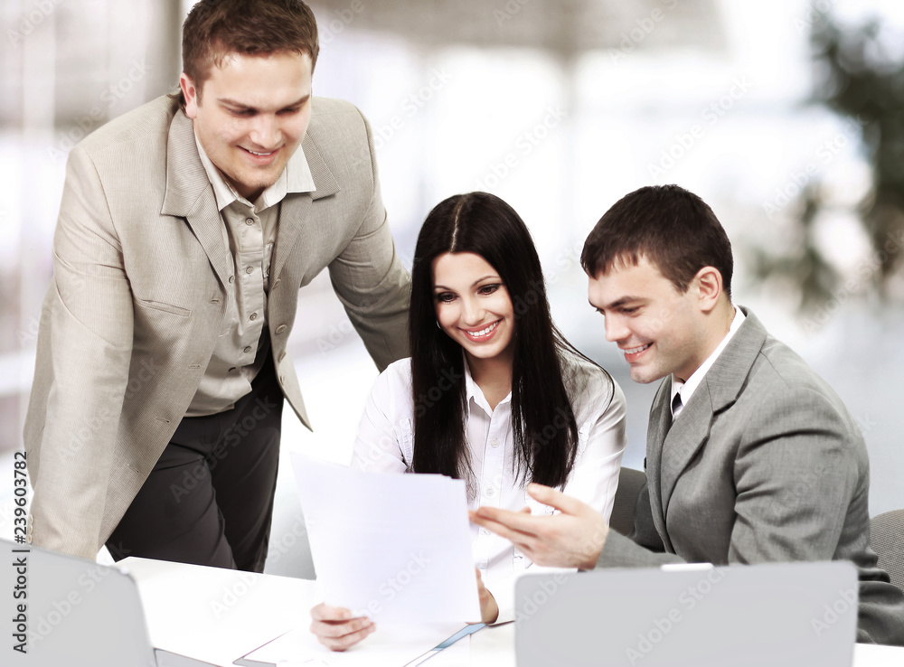 Young businesspeople discuss the new project in office. Young businesspeople discuss the new project in office.