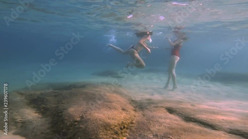 girls in thong play underwater 4k photo