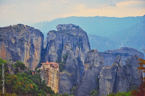 Monastery Meteora Greece. Stunning summer panoramic landscape. View at mountains and green forest against epic blue sky with clouds. UNESCO heritage list object. © raisondtre