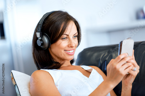 Young woman with headphones sitting at home
