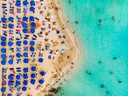 Amazing Aerial View from Above over Nissi Beach in Cyprus. Nissi Beach At high tide. Tourists relax on the beach. Crowded beach with lots of tourists. A popular place.